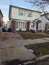 Colonial home with brick siding