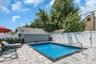 In-ground swimming pool 3' to 6' featuring custom paver perimeter patio