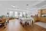 Dining area with light wood-type flooring and crown molding
