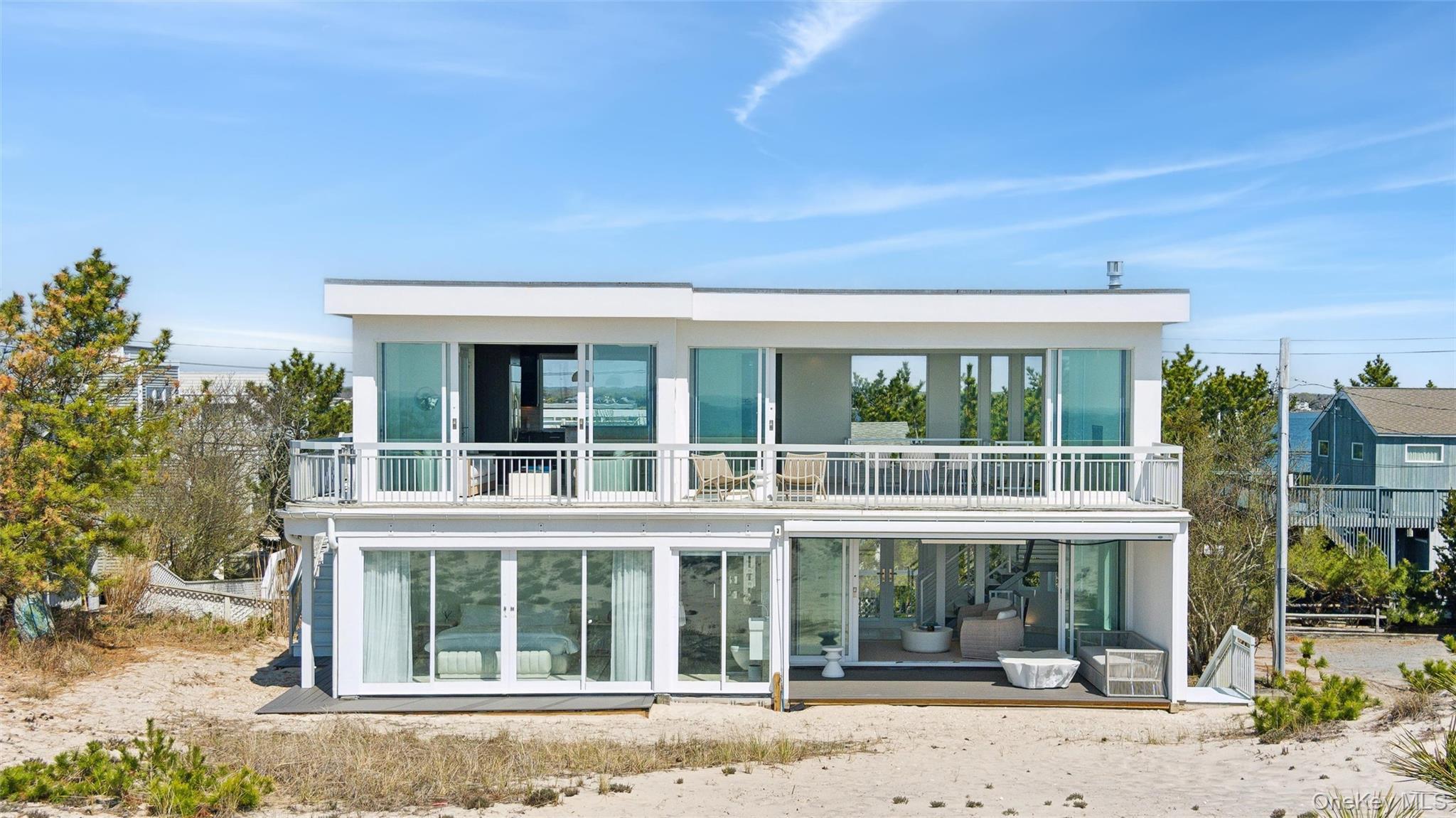 Rear view of house with a balcony and stucco siding