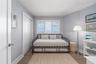 Bedroom with baseboards, wood finished floors, and a closet