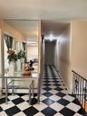 Hall featuring light floors and baseboards
