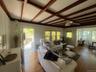 Living area with wood finished floors, beamed ceiling, ceiling fan, and coffered ceiling