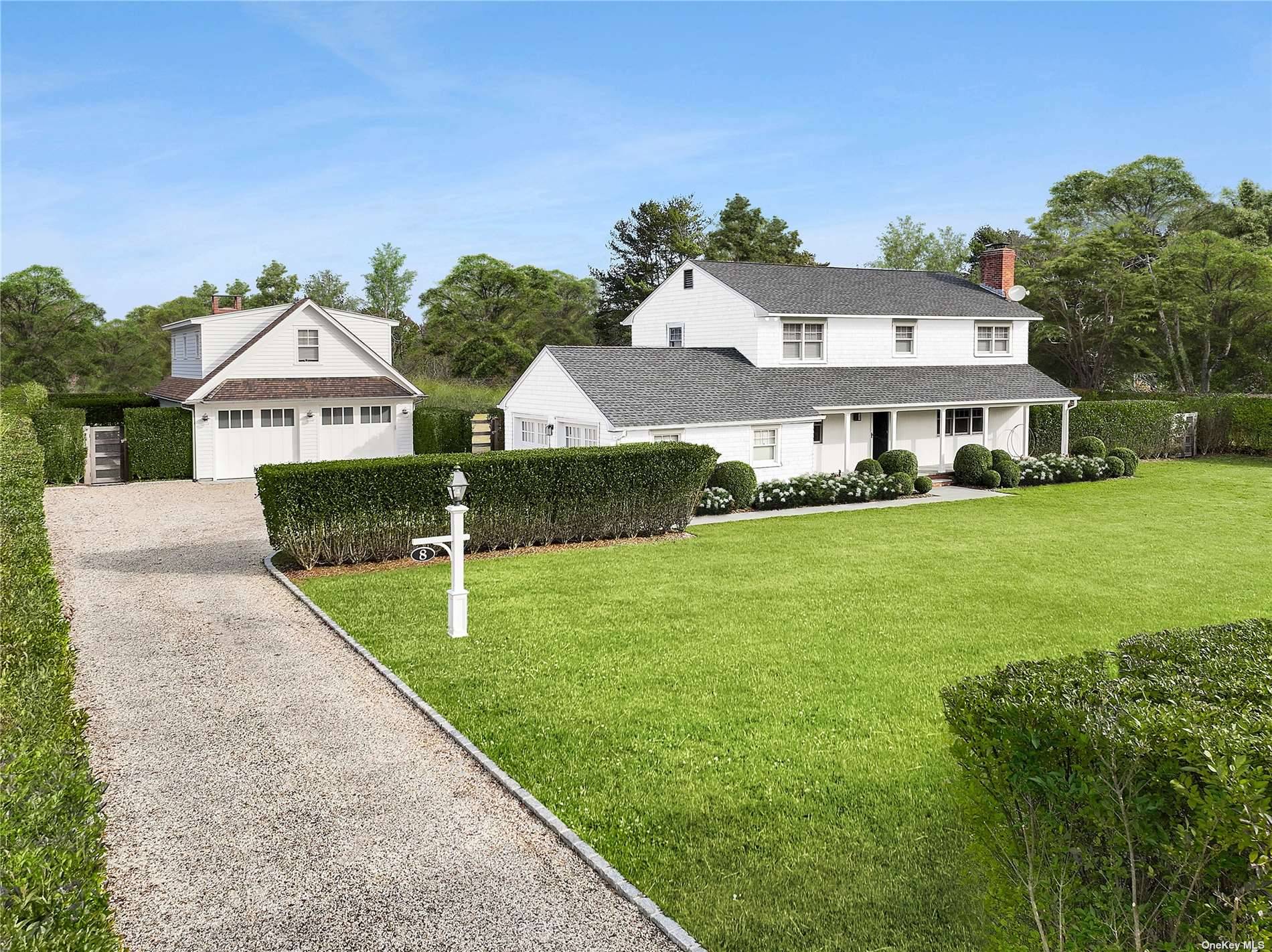 Located down a quiet cul de sac lane in the bucolic hamlet of Remsenburg, this classic Hamptons Farmhouse stands tall on a privately hedged acre, fully fenced and beautifully landscaped.