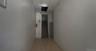 Corridor with light tile patterned floors