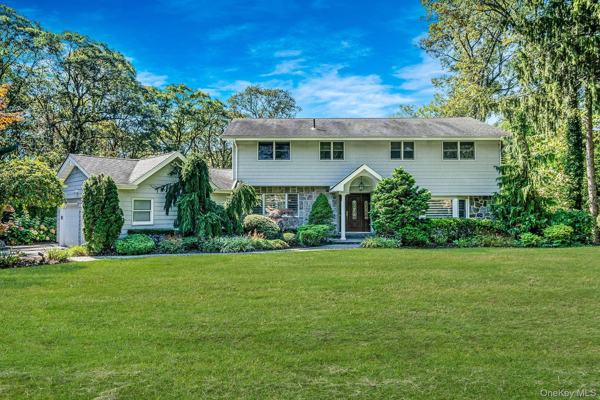 Welcome to 6 Buckingham Drive, a beautifully updated colonial nestled on a serene, perfectly located mid block on a 1 acre lot in the heart of Dix Hills.