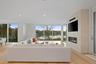 Living room featuring a tile fireplace, light hardwood / wood-style flooring, and a wealth of natural light