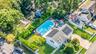 Aerial view of property and surrounding area featuring a pool