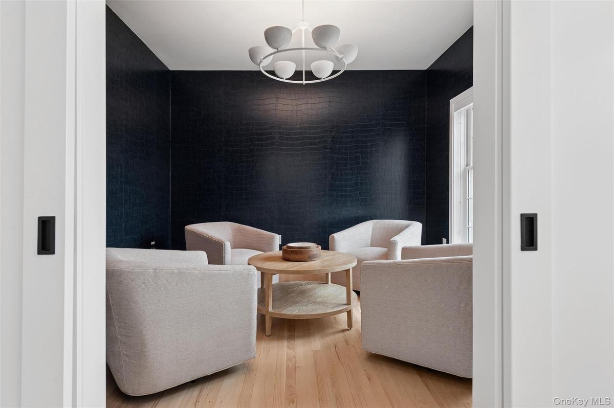 Living area featuring a notable chandelier and light wood-style floors