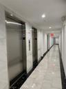 Corridor featuring elevator, recessed lighting, and tile patterned floors