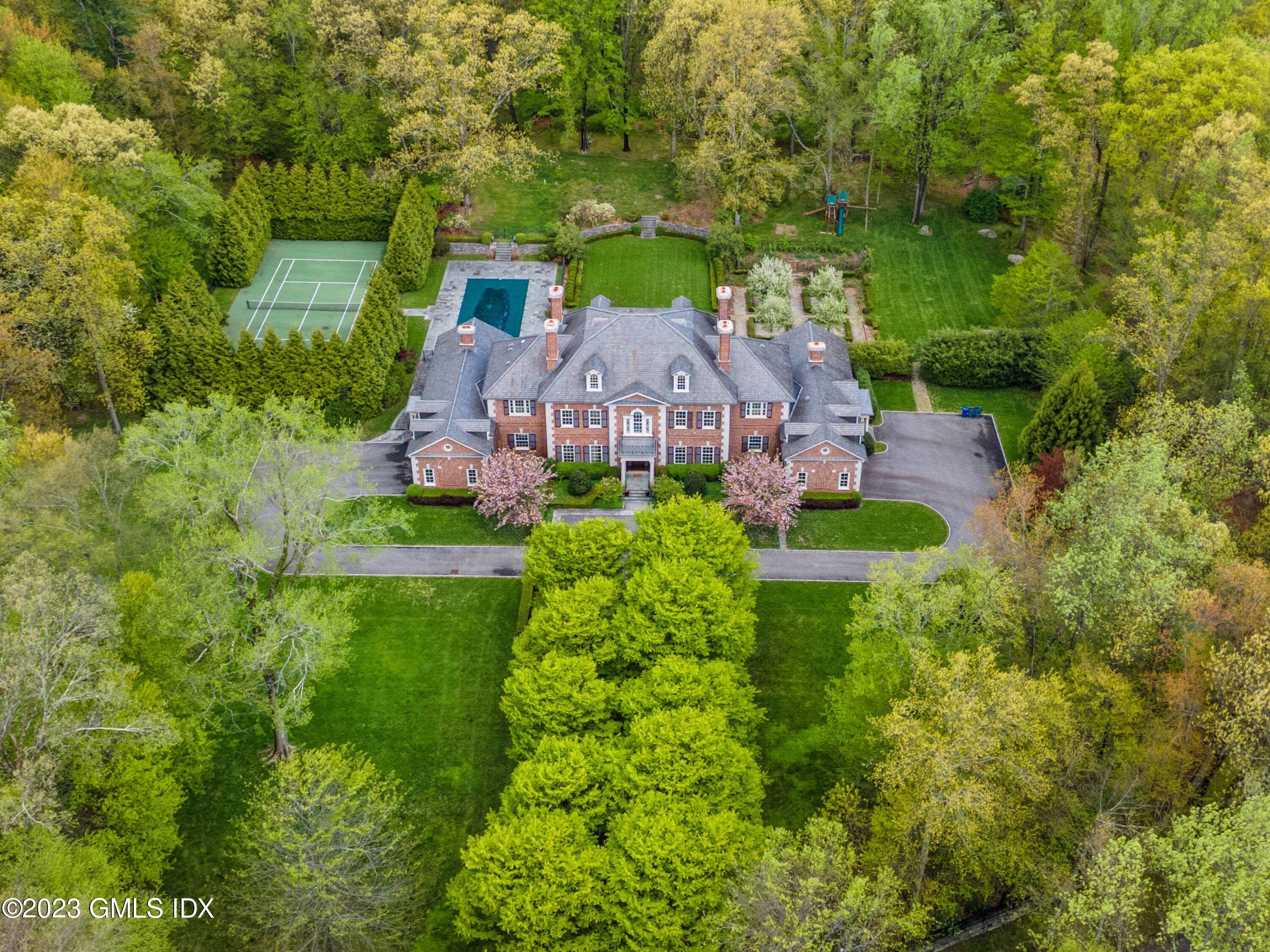 Exquisitely designed Georgian estate by award winning architect Douglas Vanderhorn built by Significant Homes sits on 4 gated acres w a pool, tennis court, gardens, expansive lawns terraces.