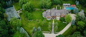 Beautiful private compound on over six lush acres with mature, William Rutherford, designed gardens.