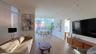 Living area featuring light wood-style floors and floor to ceiling windows