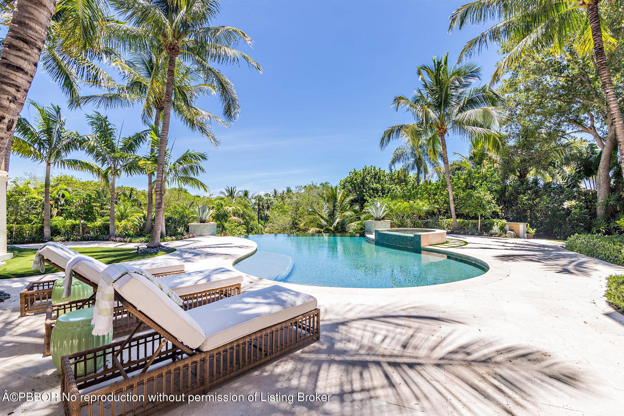 This elegant Mediterranean estate, situated on a high elevation, offers unparalleled views of the expansive tropical canopy of trees and the water below.