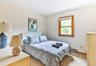 Bedroom featuring carpet and a baseboard heating unit