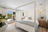 Bedroom with access to outside, wood finished floors, and ornamental molding