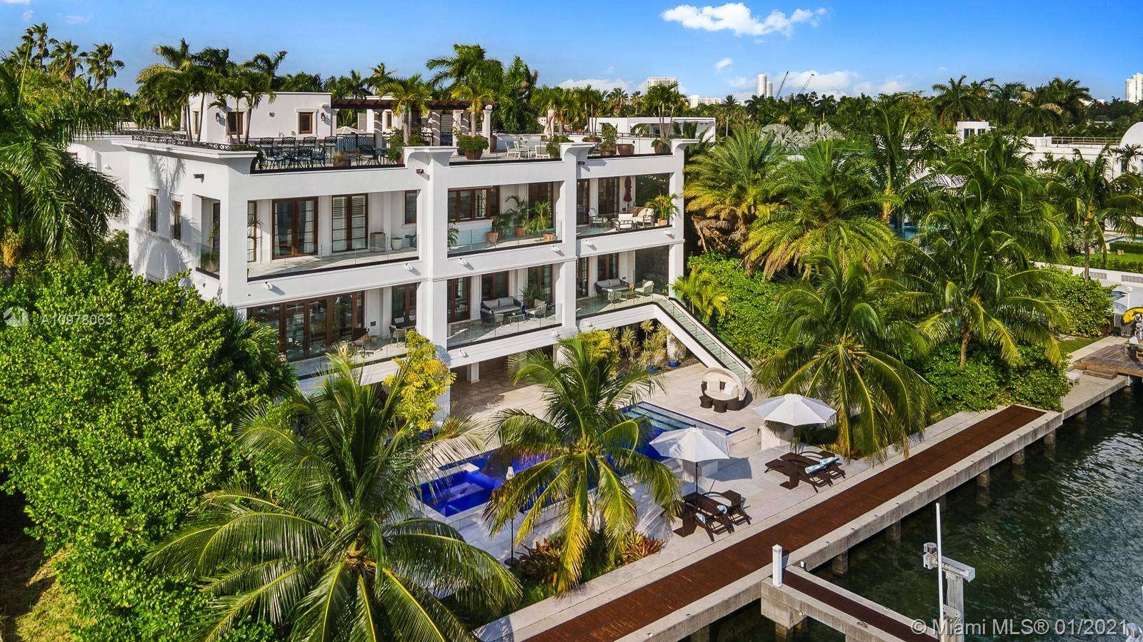 Enjoy Miami s best views from this distinguished 3 story, waterfront estate on exclusive, guard gated Palm Island.