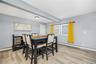 Dining room with light wood-style flooring, beam ceiling, and a baseboard heating unit