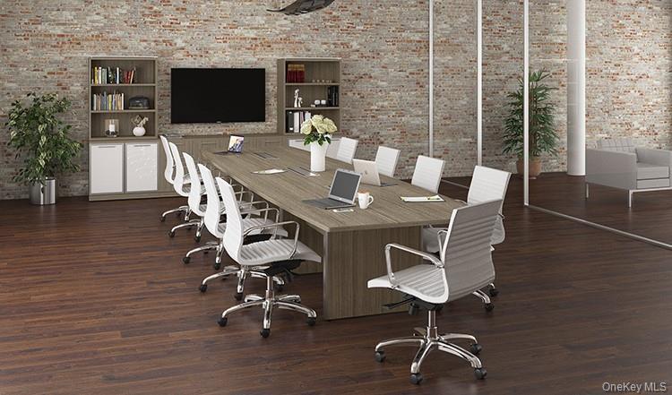 Office area featuring brick wall, wood finished floors, and built in features