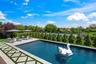 View of swimming pool with a patio and view of wooded area