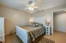 A second angle highlights the room's spacious layout, neutral palette, and direct access to the hallway for added convenience.