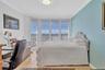 Residence Secondary or guest bedroom with floor, ceiling, windows, and plantation shutters crown, moldings, and modern lighting