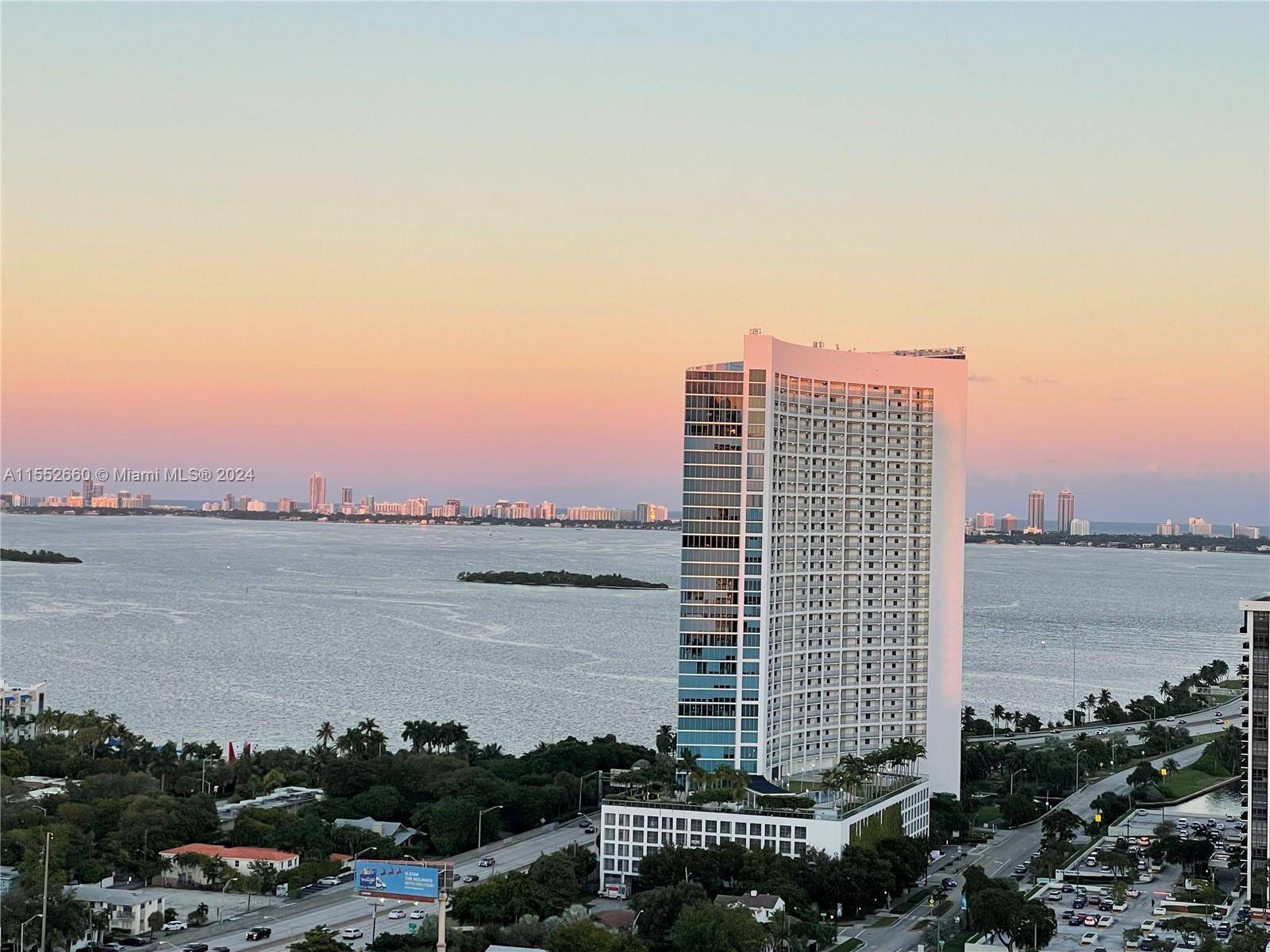 A high floor Designer unit with oversized terrace w views of the Bay, Design District Florida skyline and greenery.
