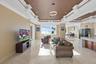 A statement space defined by dual coffered ceilings, offering endless possibilities for a game or entertainment lounge.