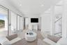 Living area featuring light wood-style floors, recessed lighting, and visible vents