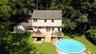 Aerial view of part of the backyard, deck, breezeway, and detached garage.