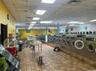 Community laundry with washing machine and dryer and brick patterned flooring