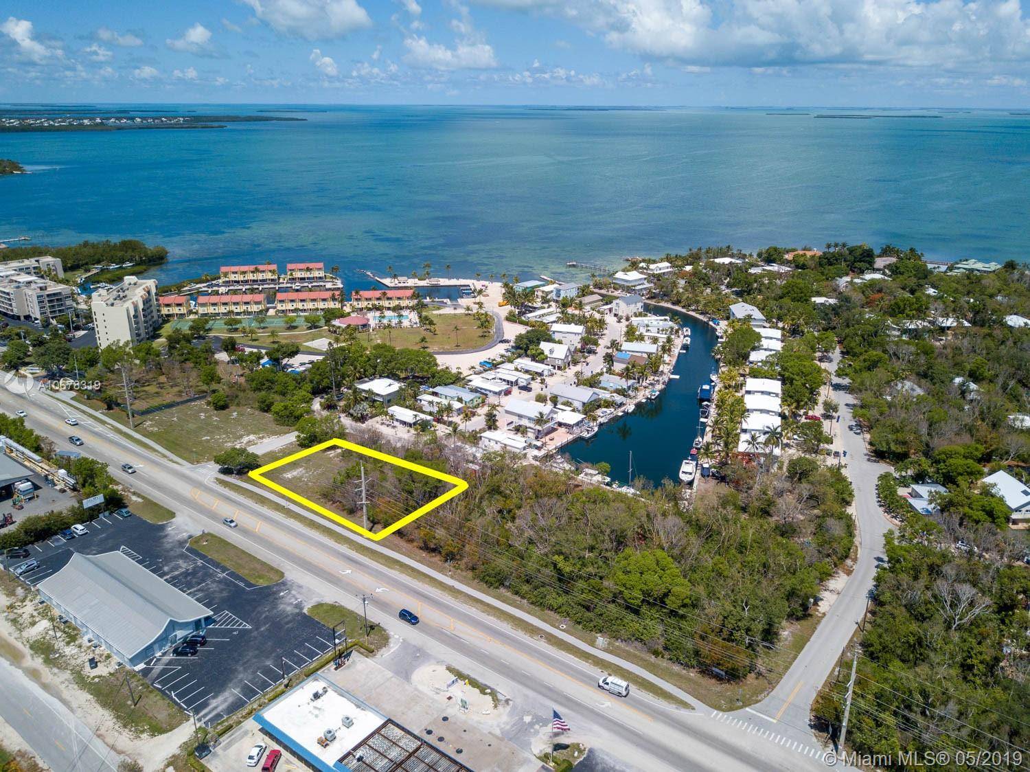 Great Opportunity. Vacant corner lot in a prime location in the Villages of Islamorada with 200' of highway frontage.