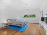 Bedroom with wood finished floors and baseboards
