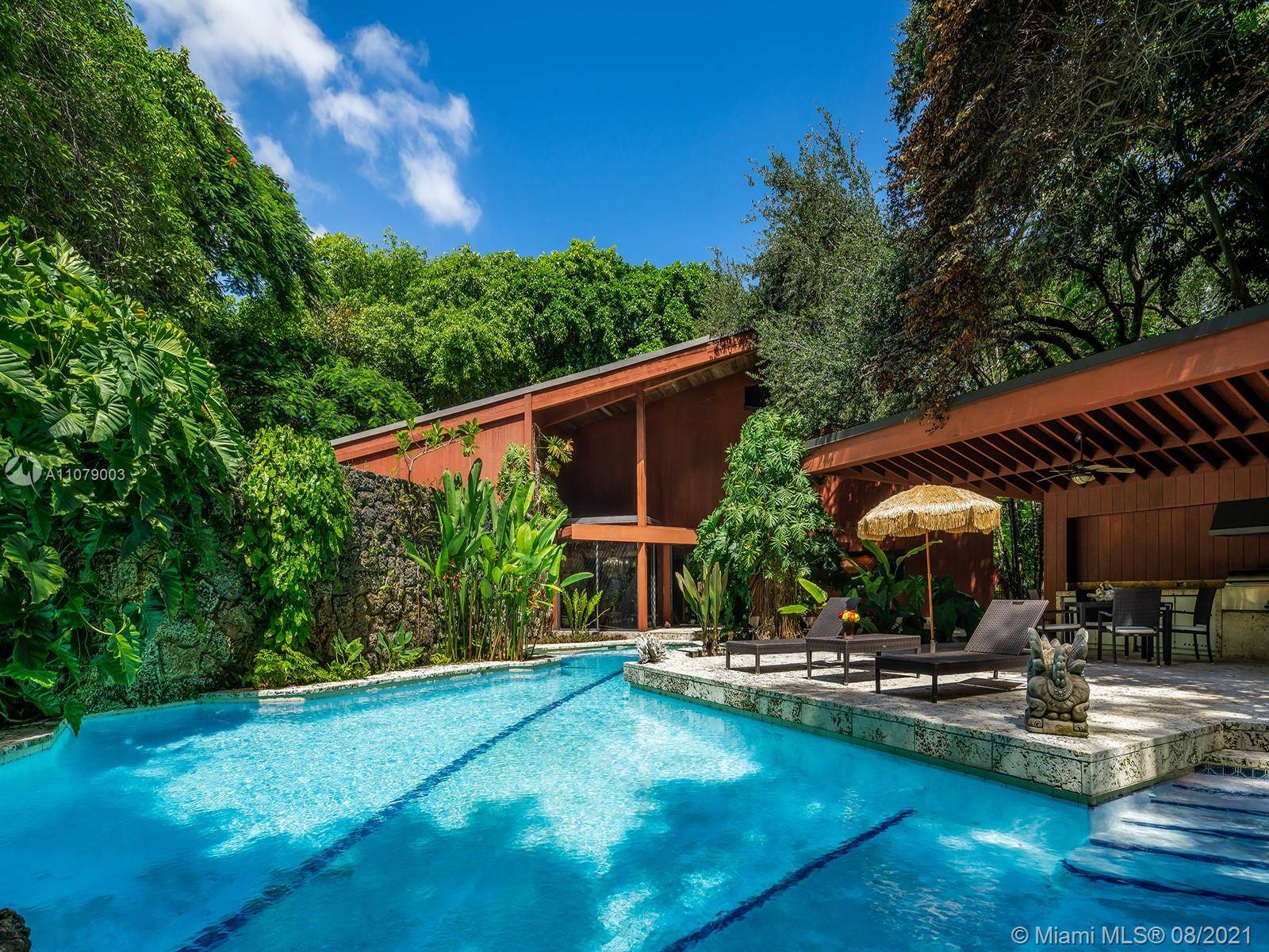 This iconic Ponce Davis home, designed by renowned Miami architect Chayo Frank as his personal residence, embraces the natural jungle environment that surrounds it, creating a truly unique and one ...