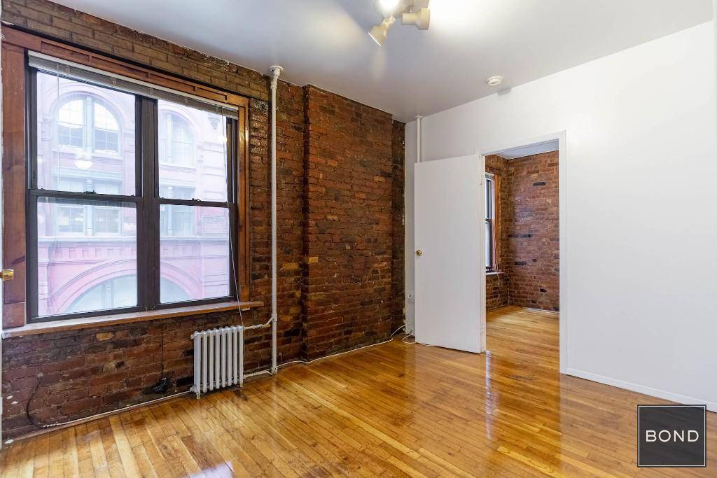 Tons of original details and charm such as exposed red brick, high ceilings, wood picture window frames.