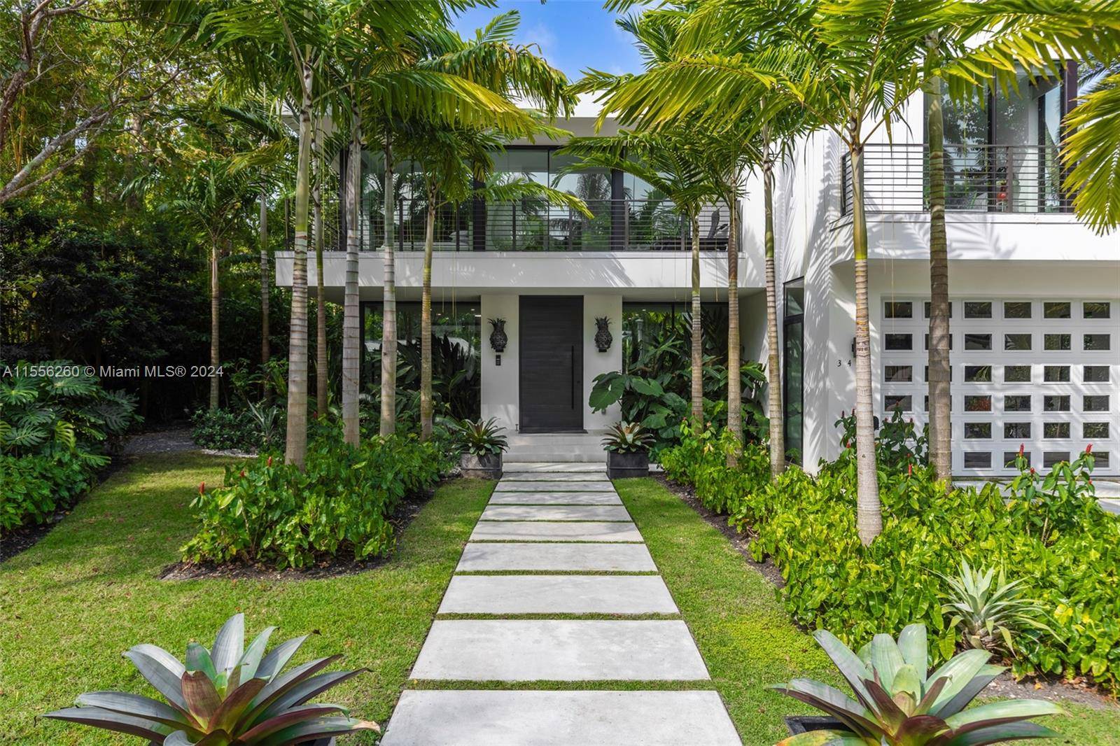 Stunning tropical modern home in the coveted guard gated community of Four Way Lodge Estates.