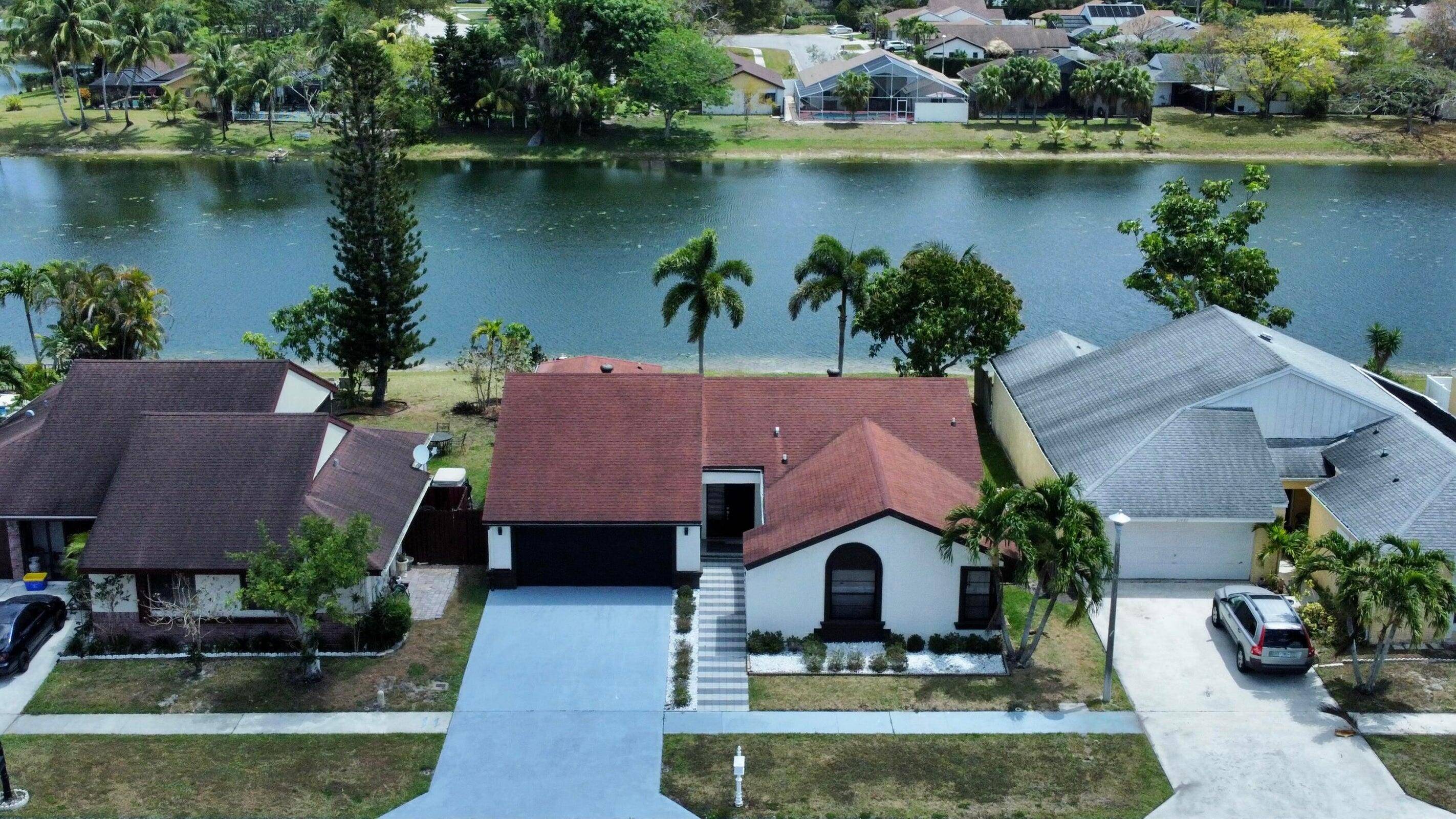 Lake view beautiful, 3 bedroom, 2 bath home with attached 2 car garage that offers extra storage.