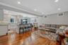 Living room featuring ornamental molding, light wood-style floors, recessed lighting, a chandelier, and a wall mounted air conditioner