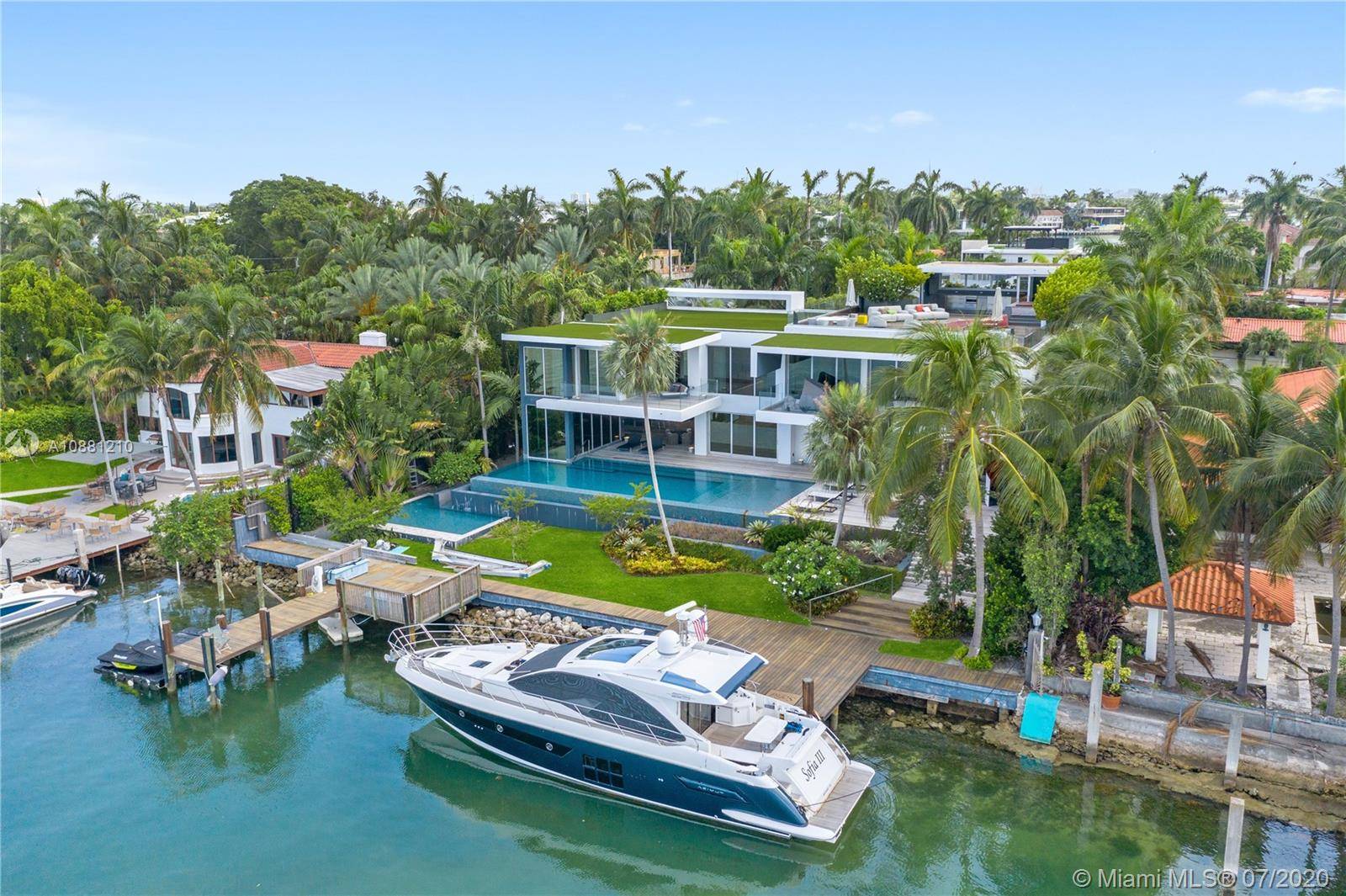 Exclusive Hibiscus Island Miami Beach modern architectural gem built 2016 on double lot w 122 ft of water frontage, South orientation.
