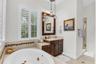 Primary bathroom with dual vanities, spa tub, toilet closet and walk-in shower