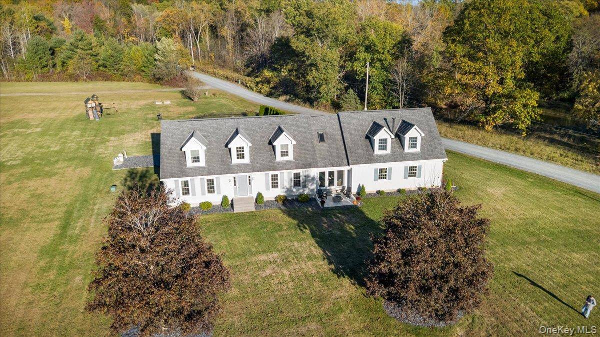 Welcome to this beautifully updated Cape Cod style home nestled on 1.