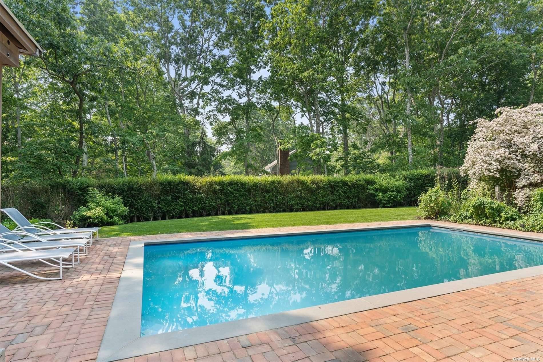 This lovely shingled, private traditional sits on a shy acre in a coveted Water Mill location.