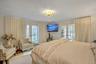 Bedroom with access to exterior, french doors, multiple windows, and ornamental molding