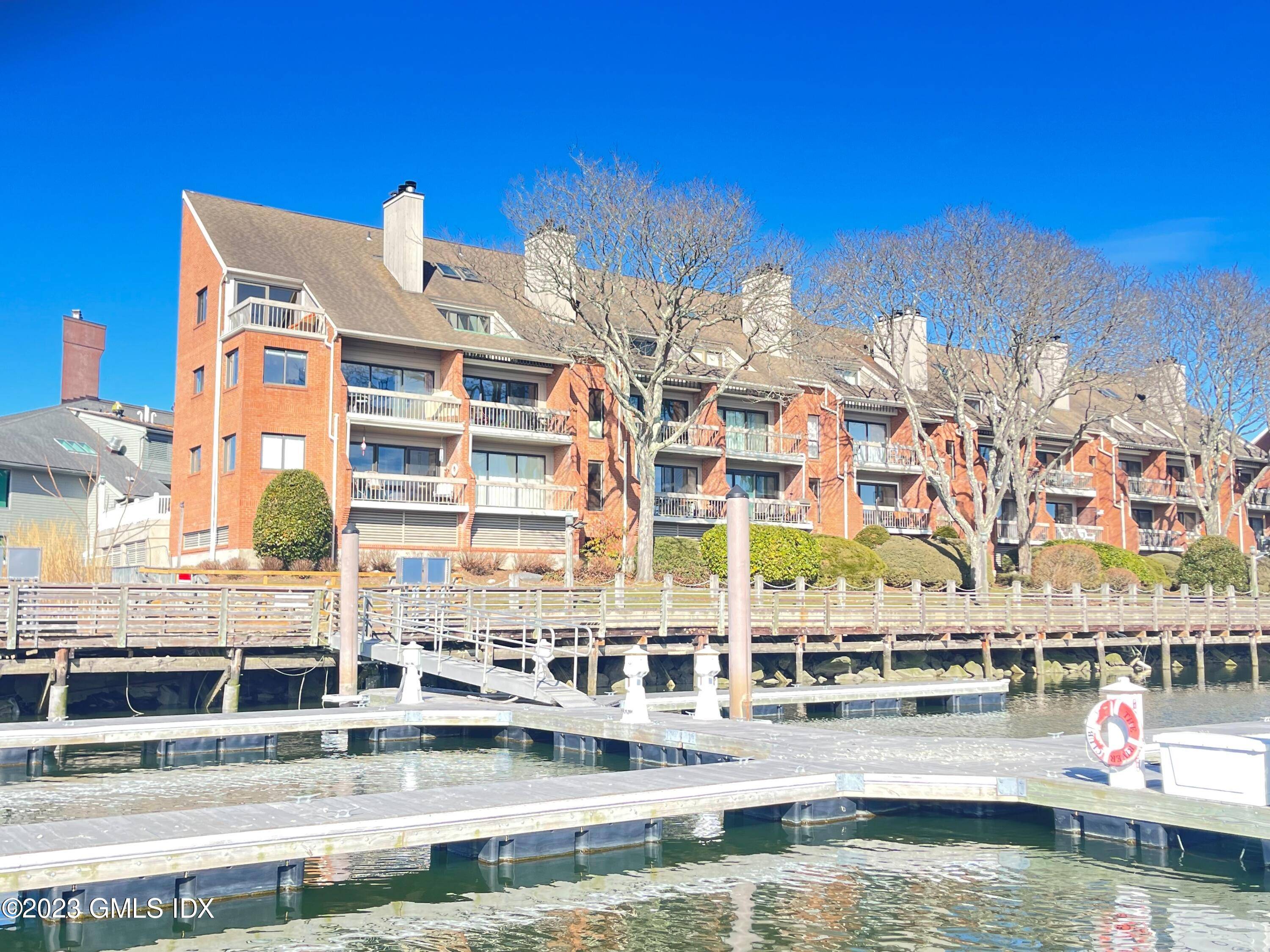 Prize of Cos Cob ! Direct waterfront enlarged end unit, privately located at Palmer Point's southernmost vantage.