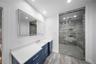 Full bathroom with vanity, a stall shower, recessed lighting, and light marble finish flooring