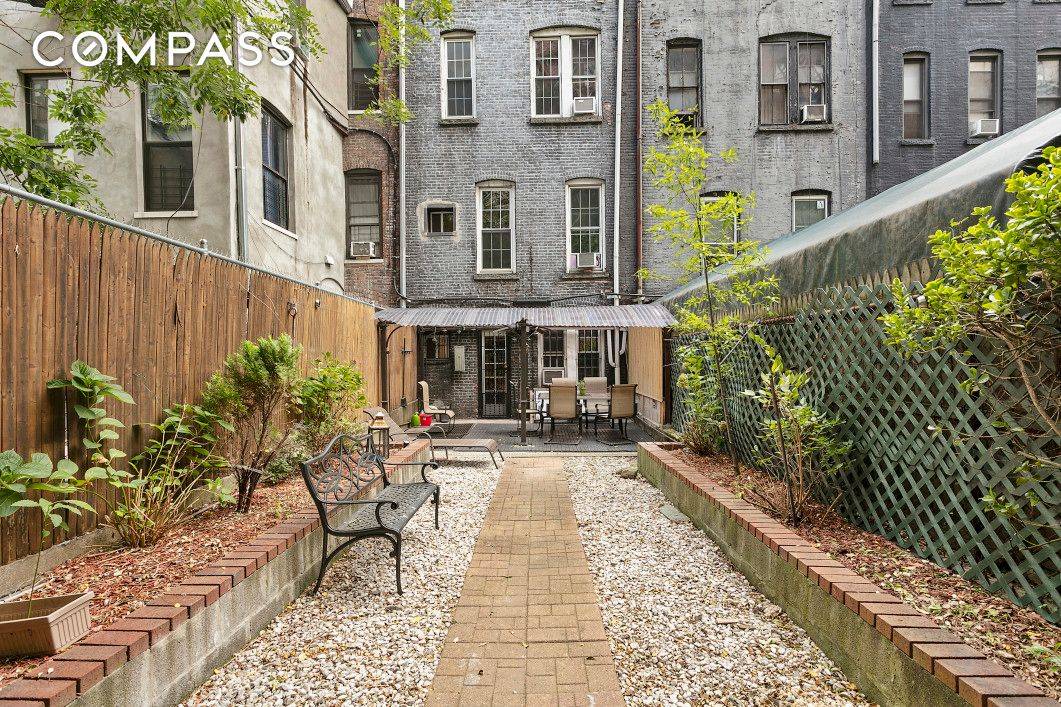 The renovated townhouse offers vintage hickory flooring throughout, 12' high Ceilings, crown molding, exposed brick, noise cancellation windows, front facing bay windows on parlor level, original tier on tier wood ...