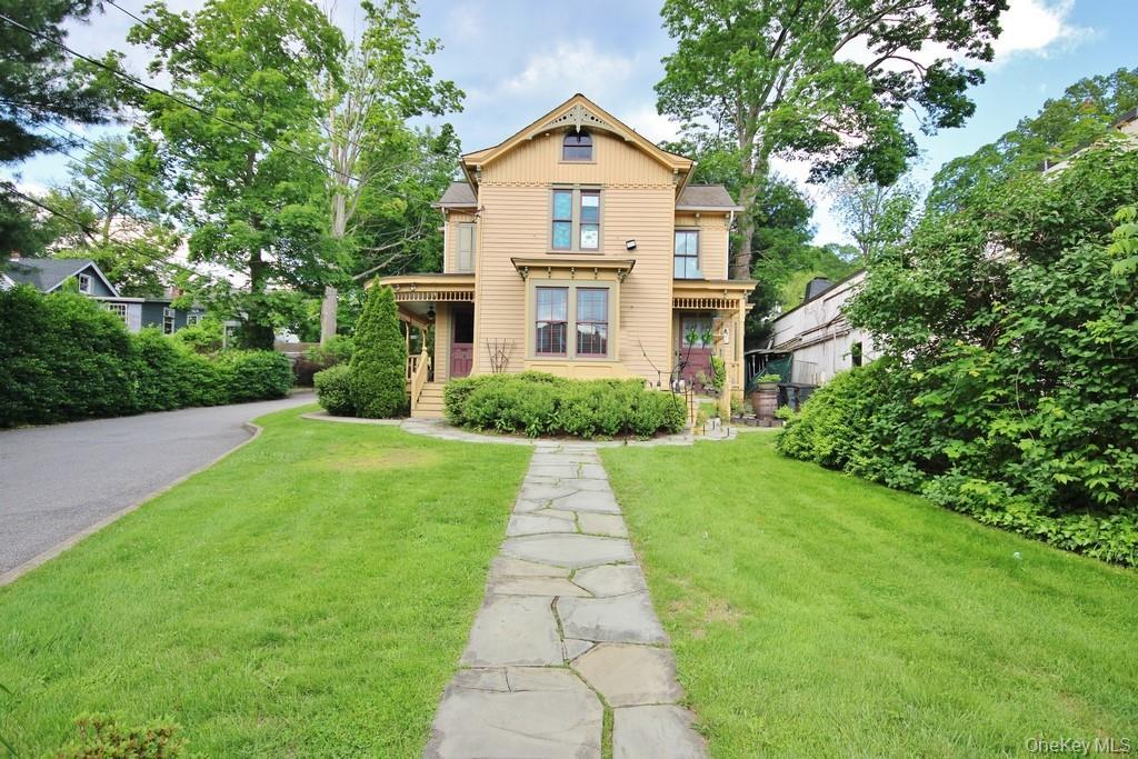Victorian house with a front yard