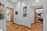 Corridor Providing Access to the Primary Suite & Secondary Bedroom with Private Bath