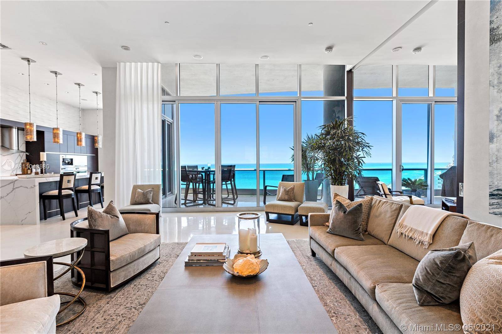 DIRECT OCEAN VIEWS FROM MODERN PH WITH SOARING 13 FOOT HIGH CEILINGS OFFER AN INCREDIBLE SENSE OF OPULENCE IN OPEN FLOORPLAN FLAWLESSLY DESIGNED BY BETHANY O NEIL OF NAPLES !