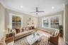 Living room featuring ornamental molding, plenty of natural light, wood finished floors, ceiling fan, and recessed lighting